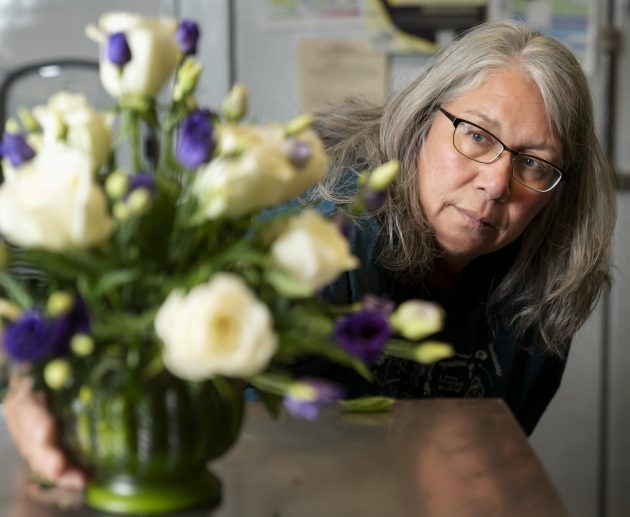 Sherie Rodekohr makes a floral arrangement.